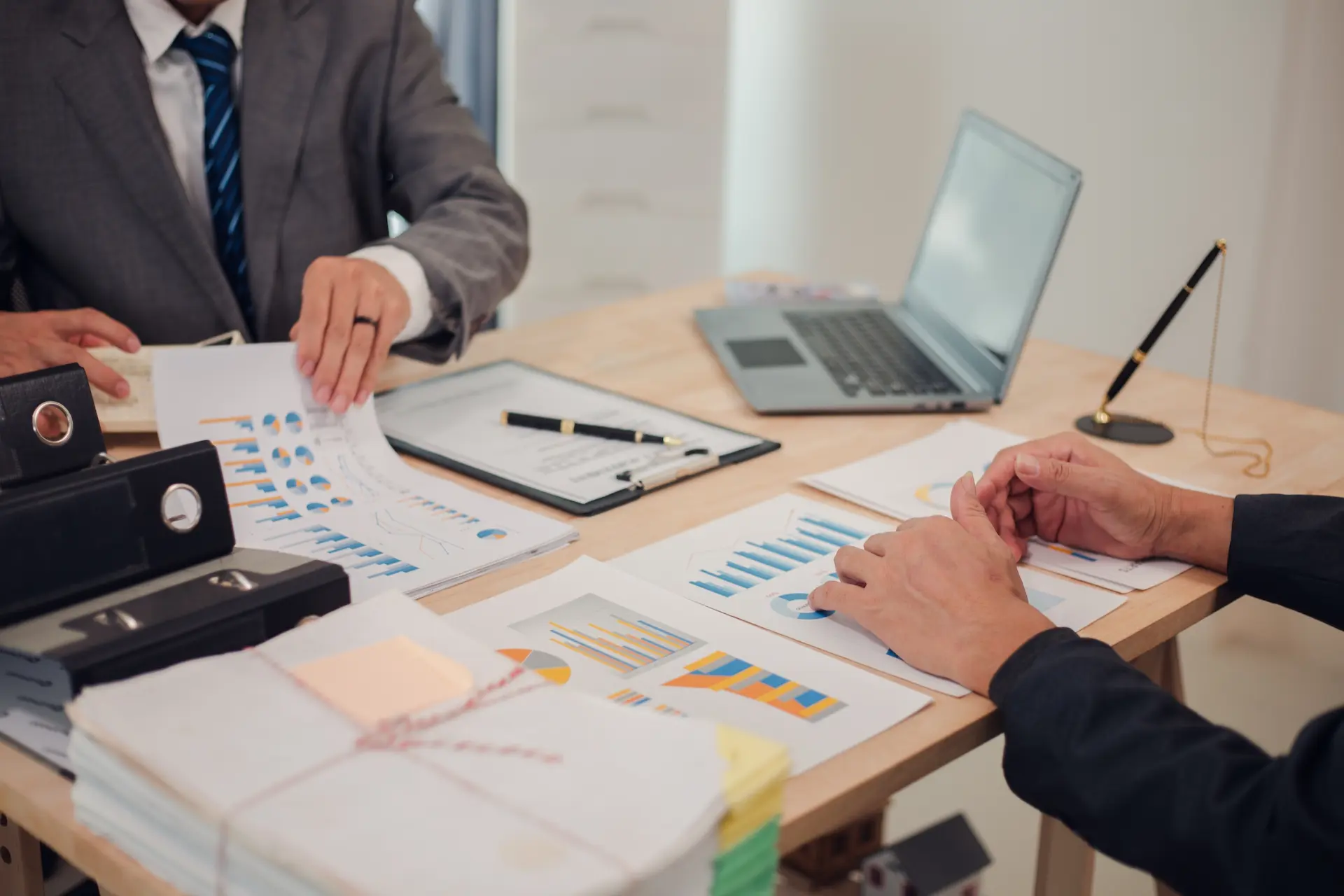 Two business people sitting at a desk going through 1 July changes for their business