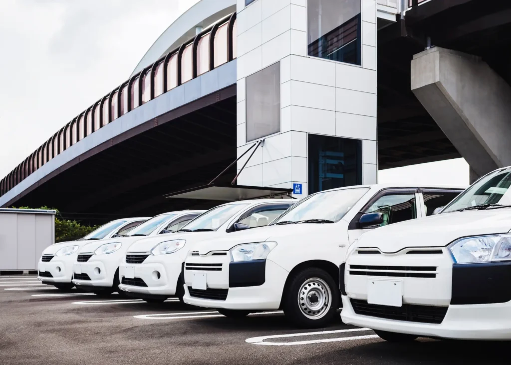 A line of company vehicles parked